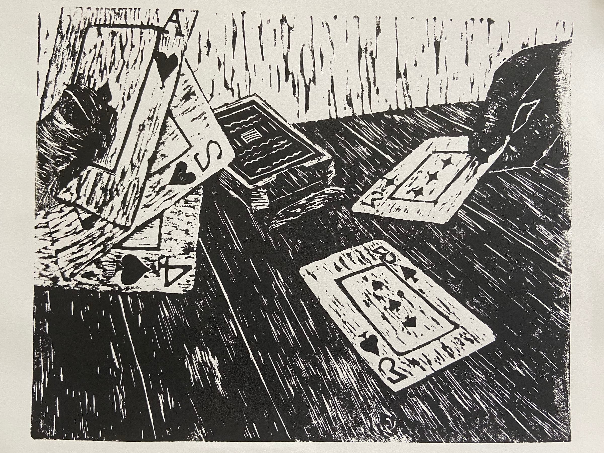 A game of cards being played on a wooden table